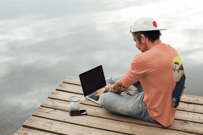 back view tee mockup of a man with an arm tattoo working outdoors m9073 r el2